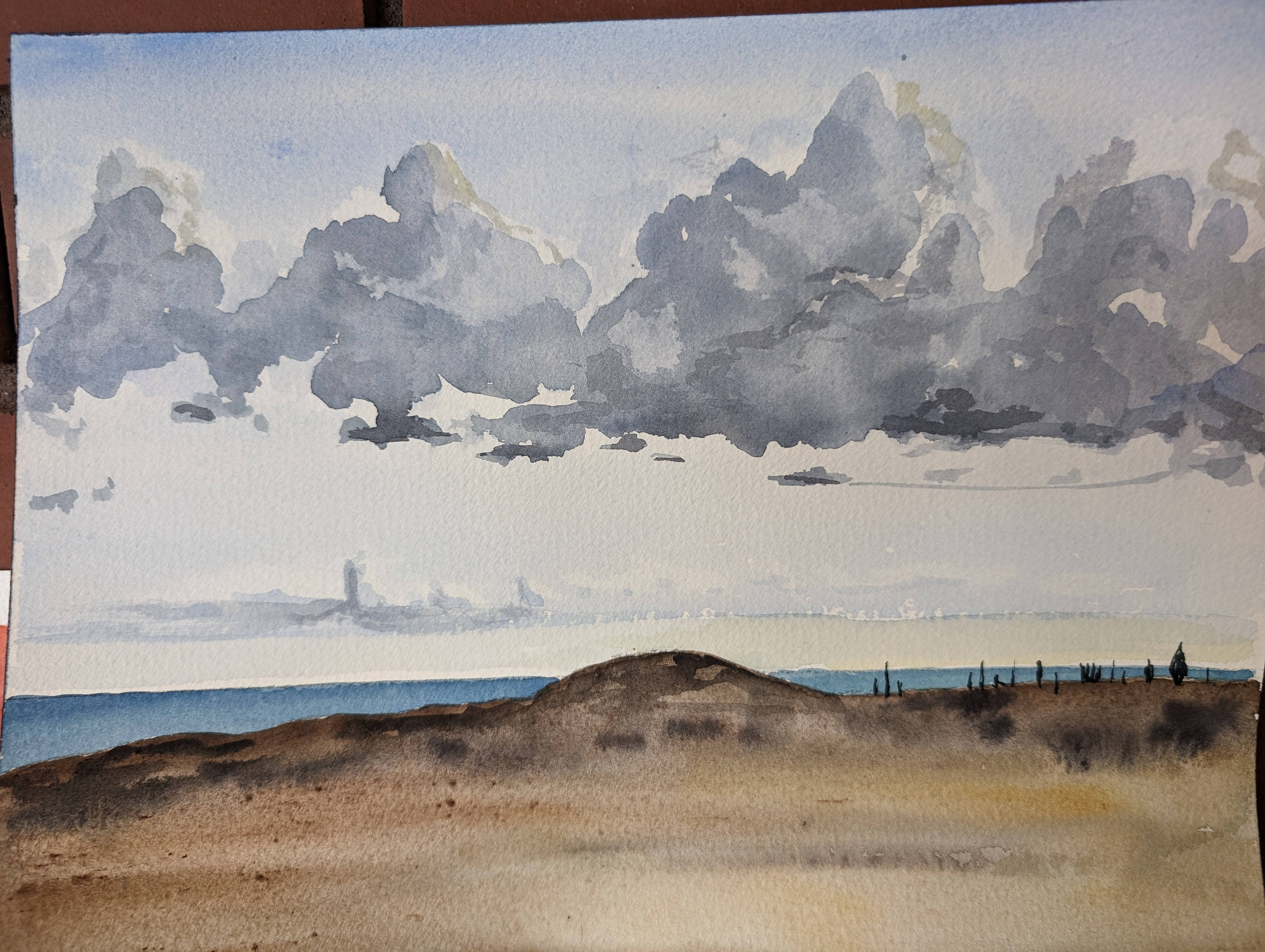 A watercolor painting of clouds over the ocean.